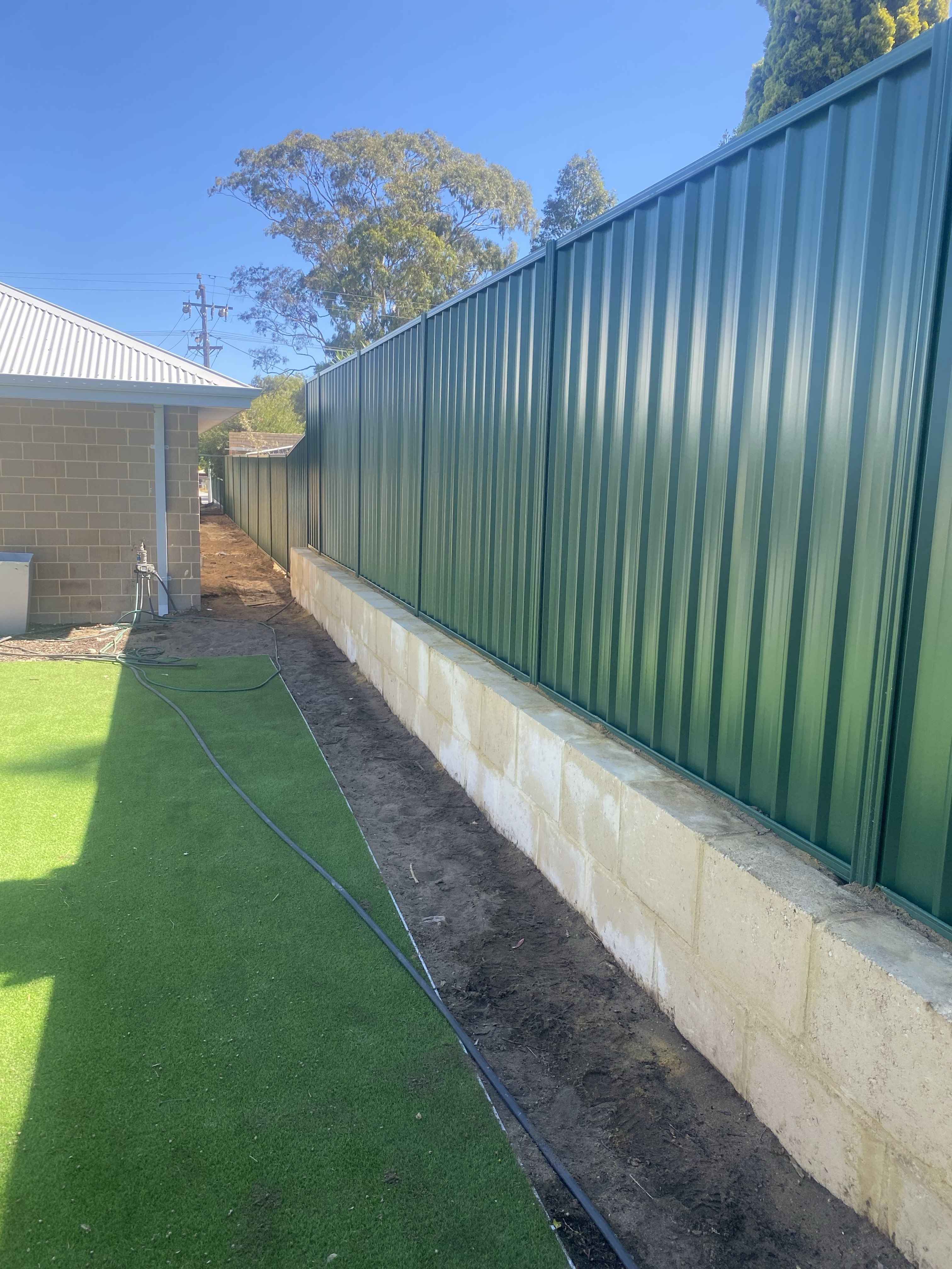 Colorbond fence installed on top of a limestone wall, Perth