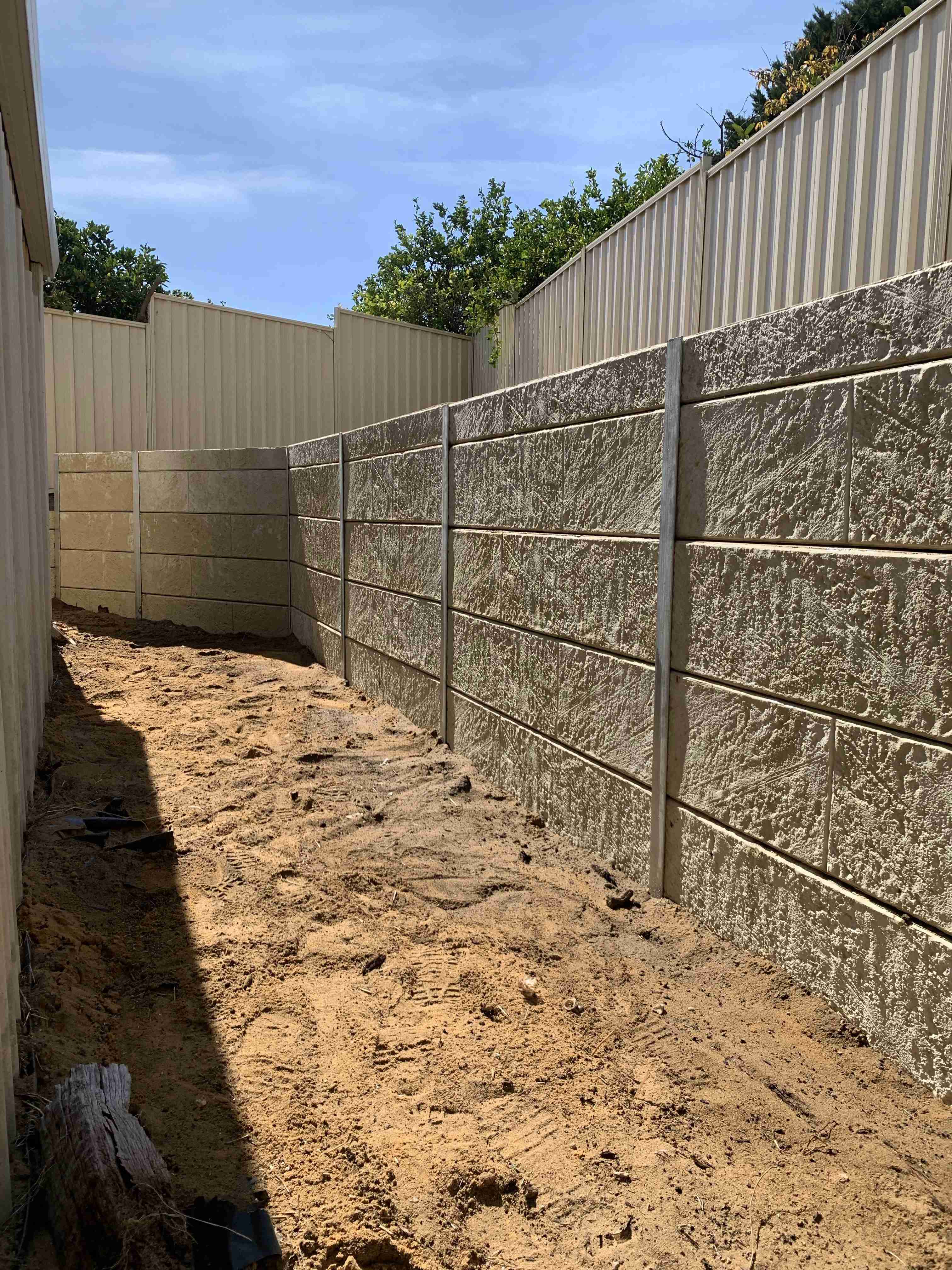 Limestone panel retaining wall built on a Perth block