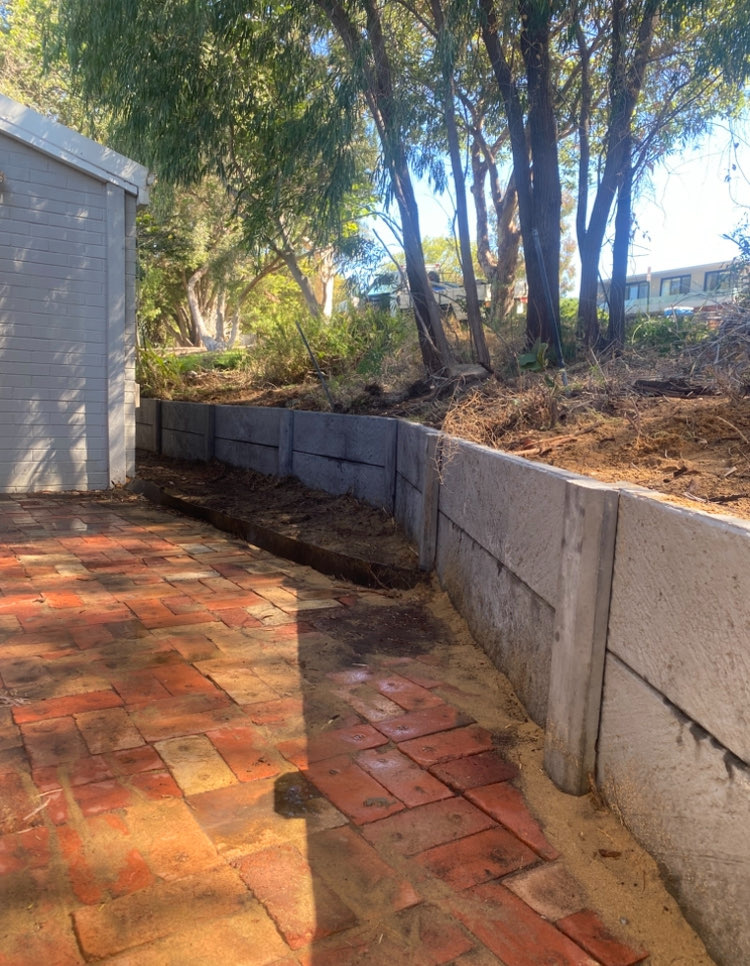 Limestone retaining wall across a sloping Perth backyard