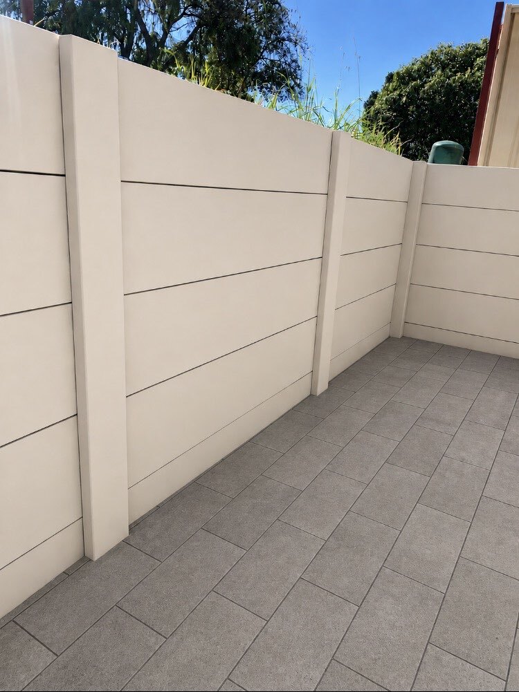 Limestone retaining wall with Colorbond fencing built on top, Perth