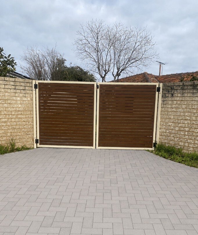 Limestone block retaining wall with timber slat gates in Perth