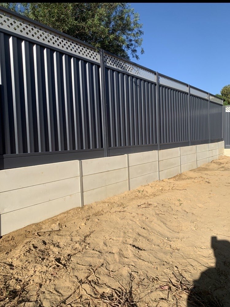 Colorbond fencing built on top of a limestone retaining wall in Perth